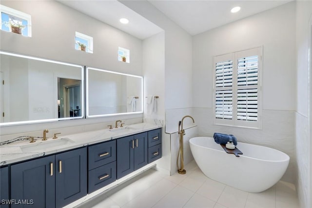 16017 Delarosa Ln, Naples, FL 34110 - bathroom featuring a freestanding bath, tile patterned floors, a sink, and double vanity