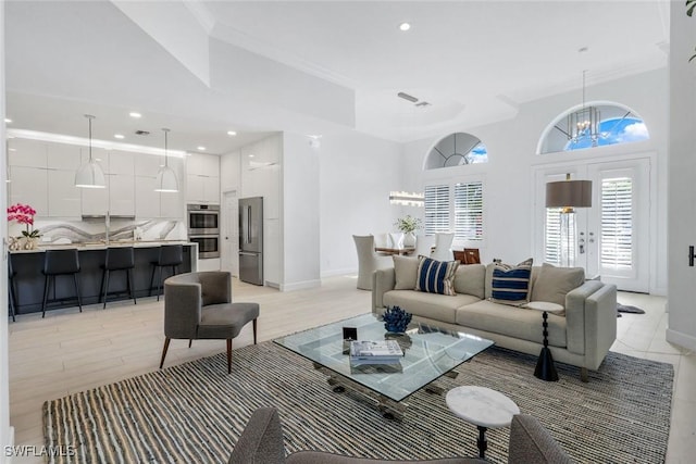 16017 Delarosa Ln, Naples, FL 34110 - living area featuring baseboards, a towering ceiling, an inviting chandelier, recessed lighting, and ornamental molding