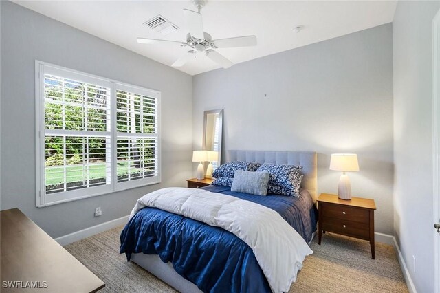 16017 Delarosa Ln, Naples, FL 34110 - carpeted bedroom featuring baseboards, a ceiling fan, and visible vents