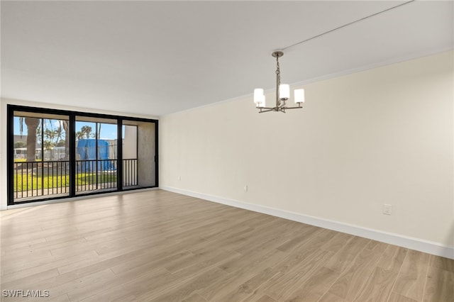 1501 Middle Gulf Dr Unit I-101, Sanibel, FL 33957 - unfurnished room with crown molding, baseboards, floor to ceiling windows, light wood-style floors, and a notable chandelier