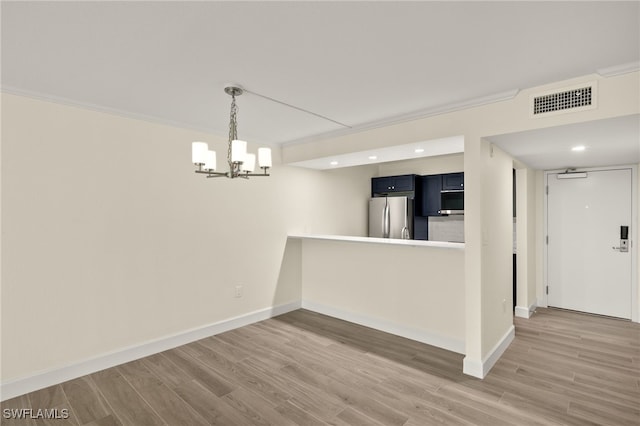 1501 Middle Gulf Dr Unit I-101, Sanibel, FL 33957 - interior space featuring baseboards, visible vents, a notable chandelier, and wood finished floors