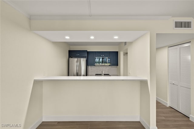 1501 Middle Gulf Dr Unit I-101, Sanibel, FL 33957 - kitchen with a peninsula, blue cabinets, appliances with stainless steel finishes, and visible vents