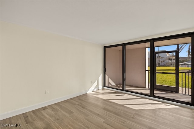1501 Middle Gulf Dr Unit I-101, Sanibel, FL 33957 - empty room featuring baseboards and wood finished floors