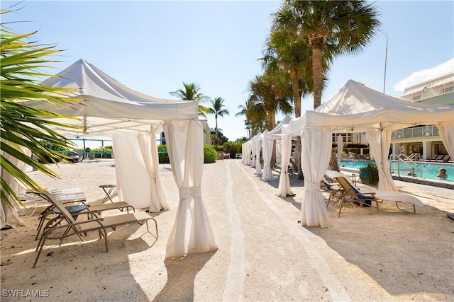 1501 Middle Gulf Dr Unit I-101, Sanibel, FL 33957 - view of patio / terrace featuring a community pool