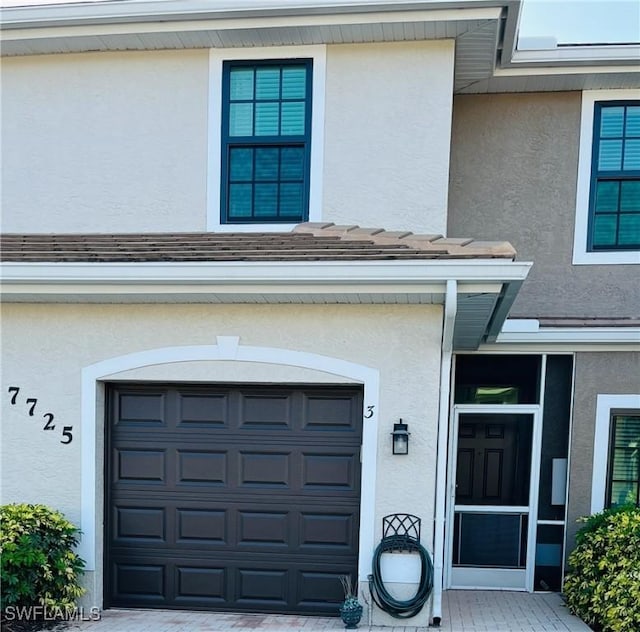 7725 Woodbrook Cir Unit 3503, Naples, FL 34104 - property entrance featuring stucco siding and an attached garage