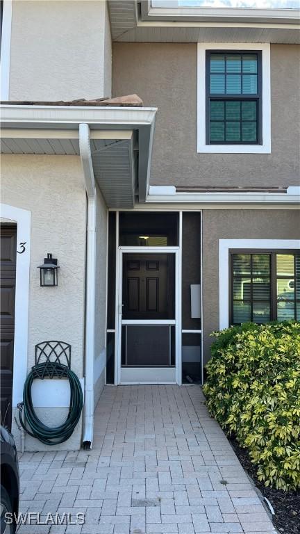 7725 Woodbrook Cir Unit 3503, Naples, FL 34104 - doorway to property featuring stucco siding