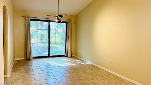 7725 Woodbrook Cir Unit 3503, Naples, FL 34104 - unfurnished room with arched walkways, light tile patterned floors, baseboards, lofted ceiling, and a ceiling fan