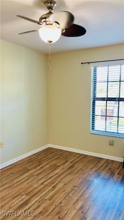 7725 Woodbrook Cir Unit 3503, Naples, FL 34104 - empty room featuring ceiling fan, wood finished floors, and baseboards