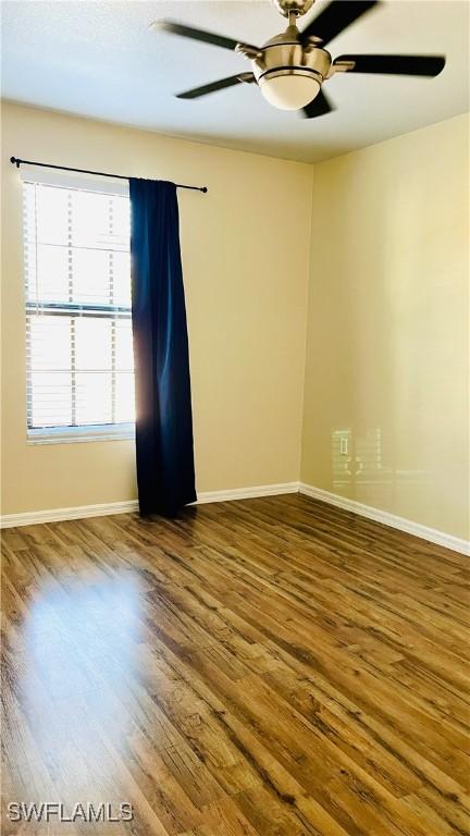 7725 Woodbrook Cir Unit 3503, Naples, FL 34104 - spare room featuring wood finished floors, baseboards, and a ceiling fan