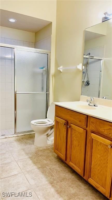 7725 Woodbrook Cir Unit 3503, Naples, FL 34104 - full bathroom with a stall shower, tile patterned floors, vanity, and toilet