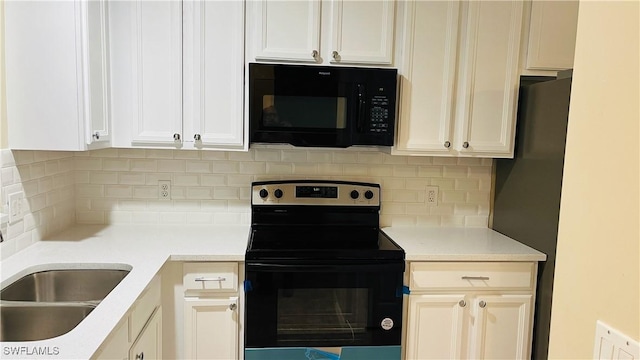 7725 Woodbrook Cir Unit 3503, Naples, FL 34104 - kitchen featuring black appliances, decorative backsplash, light countertops, and white cabinetry