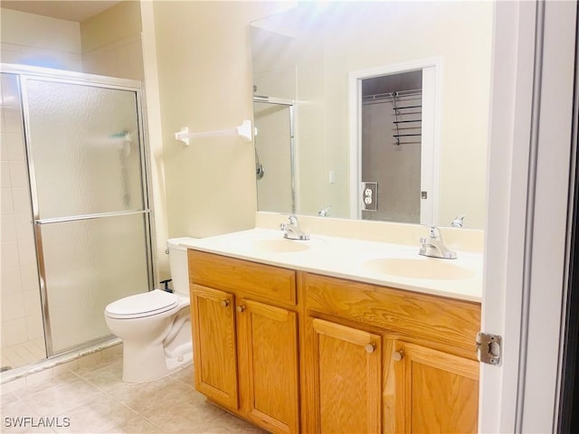 7725 Woodbrook Cir Unit 3503, Naples, FL 34104 - bathroom featuring a shower stall, tile patterned floors, double vanity, and toilet