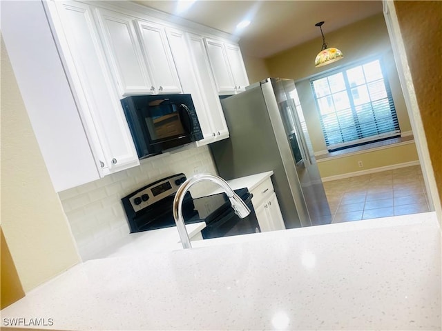7725 Woodbrook Cir Unit 3503, Naples, FL 34104 - kitchen with appliances with stainless steel finishes, white cabinets, decorative backsplash, decorative light fixtures, and baseboards