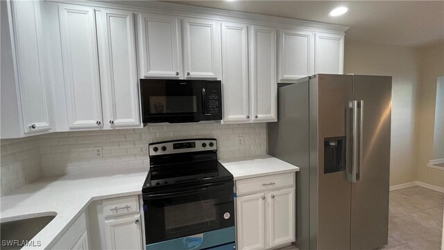 7725 Woodbrook Cir Unit 3503, Naples, FL 34104 - kitchen featuring black appliances, white cabinets, tasteful backsplash, light countertops, and baseboards