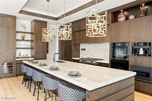 kitchen featuring open shelves, a chandelier, modern cabinets, and a sink