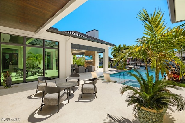 pool with an outdoor hangout area and a patio
