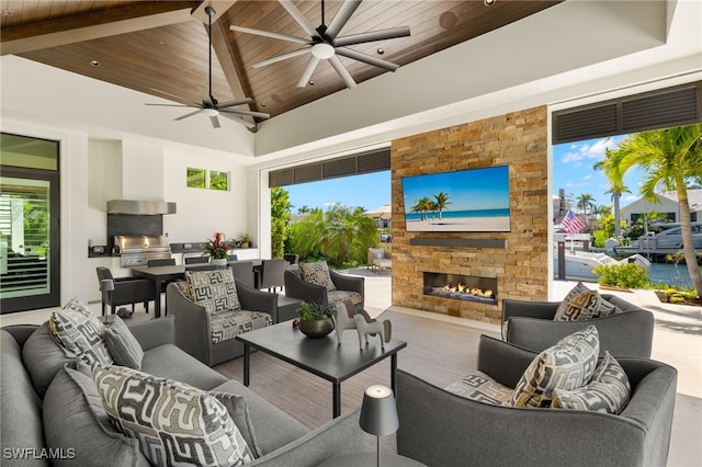 view of patio / terrace with an outdoor living space with a fireplace, grilling area, a ceiling fan, and area for grilling