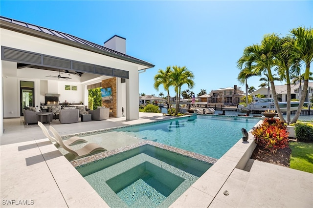 view of swimming pool featuring a patio area, ceiling fan, a pool with connected hot tub, area for grilling, and an outdoor living space