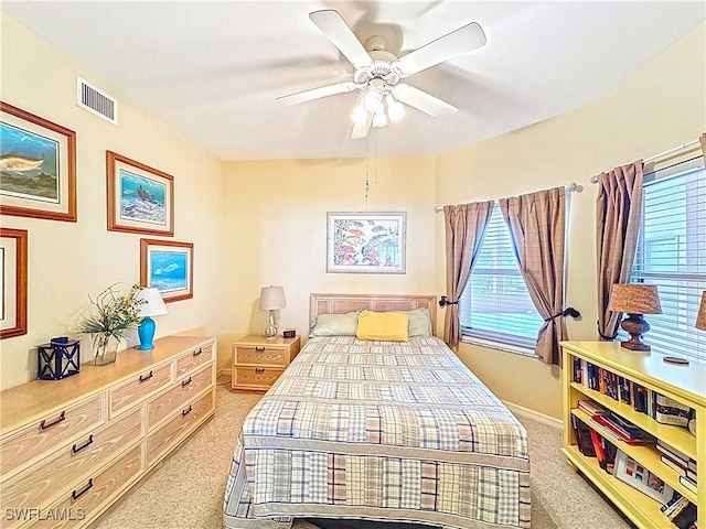 bedroom with light carpet, baseboards, ceiling fan, and visible vents