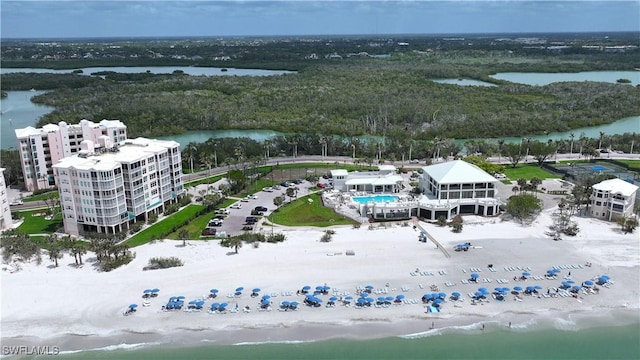 aerial view featuring a wooded view and a water view
