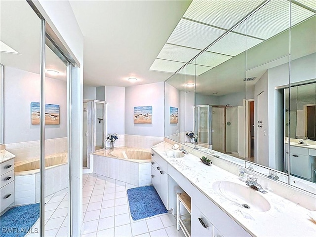 bathroom featuring tile patterned flooring, vanity, a stall shower, visible vents, and a bath