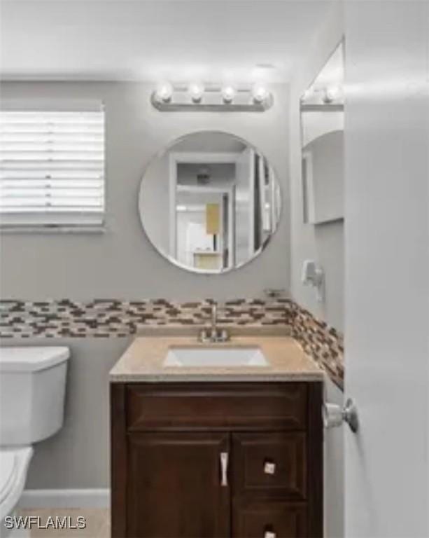 7019 Cedarhurst Dr Unit 9B, Fort Myers, FL 33919 - half bathroom with vanity, toilet, and tasteful backsplash