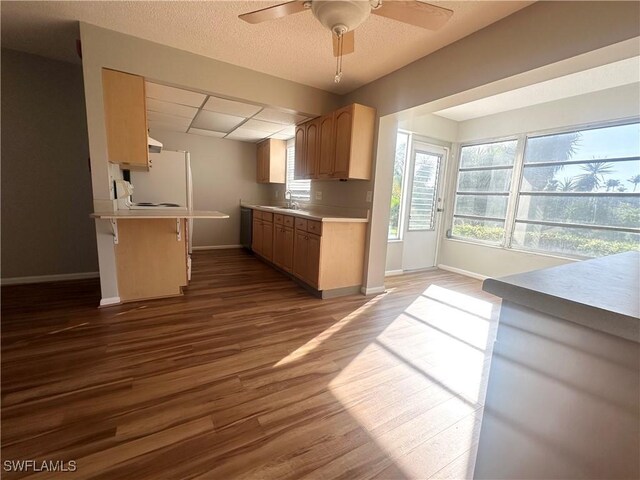 7019 Cedarhurst Dr Unit 9B, Fort Myers, FL 33919 - kitchen with baseboards, a breakfast bar area, light countertops, a ceiling fan, and dark wood finished floors