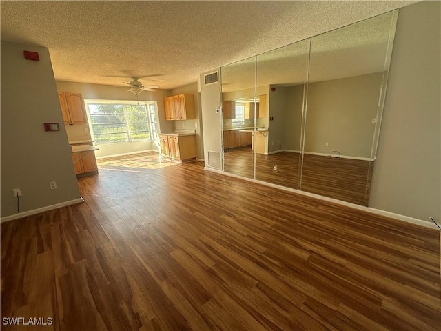 7019 Cedarhurst Dr Unit 9B, Fort Myers, FL 33919 - unfurnished living room featuring ceiling fan, a textured ceiling, visible vents, baseboards, and dark wood-type flooring