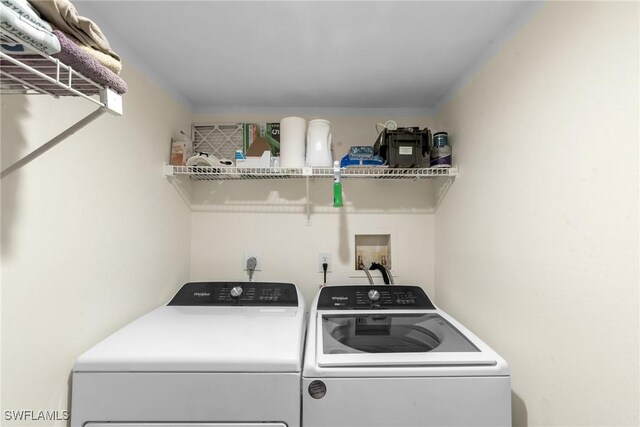 clothes washing area featuring washing machine and clothes dryer and laundry area