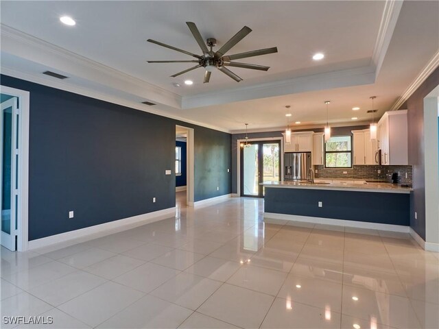 4324 22nd Ave SE, Naples, FL 34117 - kitchen with backsplash, visible vents, open floor plan, ornamental molding, and stainless steel appliances