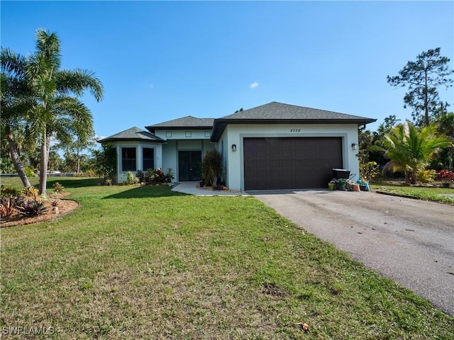 4324 22nd Ave SE, Naples, FL 34117 - prairie-style house with an attached garage, a front lawn, aphalt driveway, and stucco siding