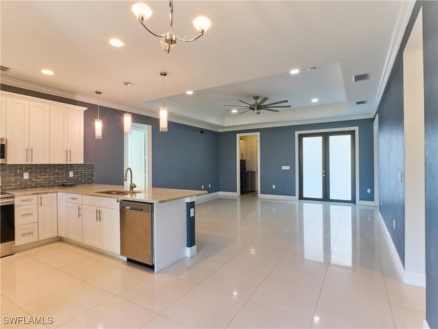 4324 22nd Ave SE, Naples, FL 34117 - kitchen with a sink, a raised ceiling, stainless steel appliances, open floor plan, and tasteful backsplash