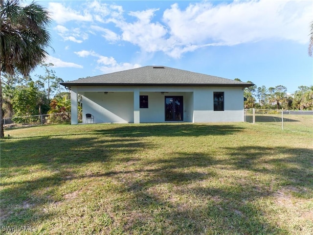 4324 22nd Ave SE, Naples, FL 34117 - rear view of house with a fenced backyard, stucco siding, and a yard