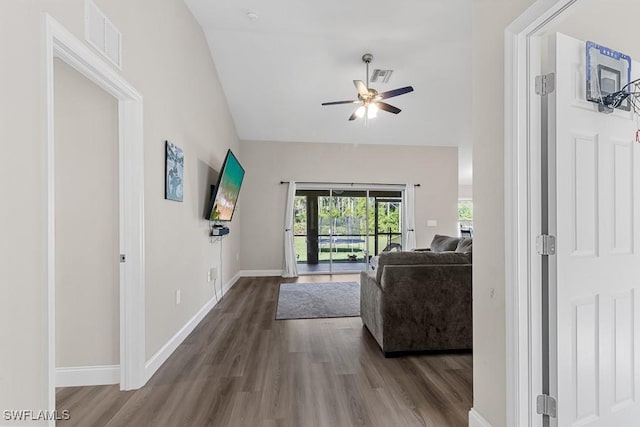 living room featuring baseboards, ceiling fan, visible vents, and wood finished floors