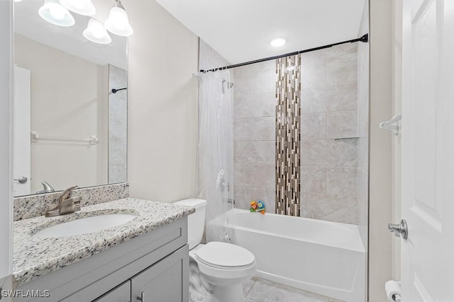 full bath featuring vanity, toilet, tile patterned flooring, and shower / tub combo