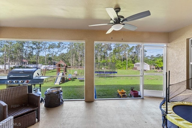 sunroom featuring ceiling fan and a healthy amount of sunlight