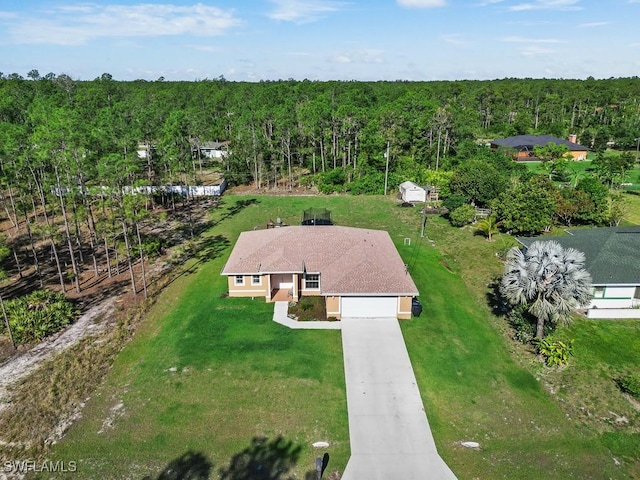 birds eye view of property with a view of trees