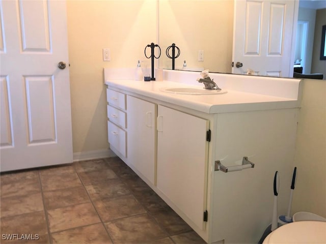 11510 Villa Grand Unit 418, Fort Myers, FL 33913 - bathroom featuring baseboards, toilet, tile patterned floors, and vanity