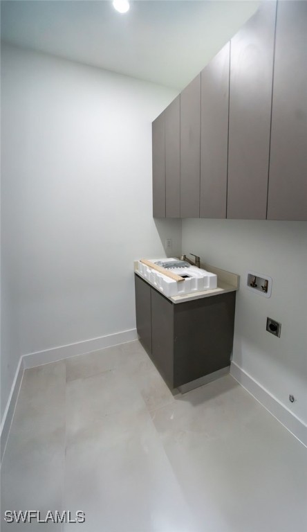 1817 NE 17th St, Cape Coral, FL 33909 - laundry area featuring electric dryer hookup, baseboards, washer hookup, cabinet space, and a sink
