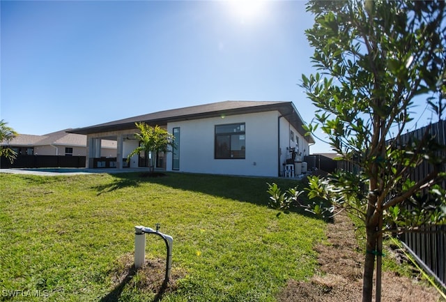 1817 NE 17th St, Cape Coral, FL 33909 - view of front of home featuring a front yard, a fenced backyard, a patio, and stucco siding