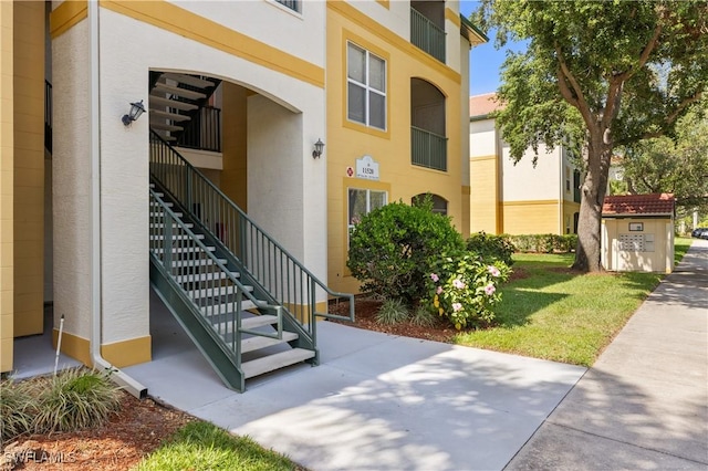 11520 Villa Grand Unit 1018, Fort Myers, FL 33913 - doorway to property with stucco siding and a lawn