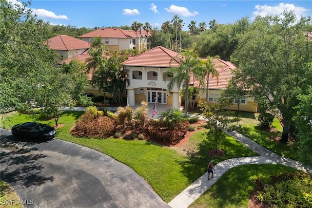 11520 Villa Grand Unit 1018, Fort Myers, FL 33913 - view of front facade with stucco siding, french doors, a front yard, and a tile roof