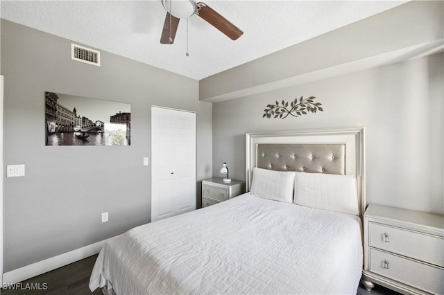 11520 Villa Grand Unit 1018, Fort Myers, FL 33913 - bedroom with a closet, a ceiling fan, visible vents, dark wood-style flooring, and baseboards