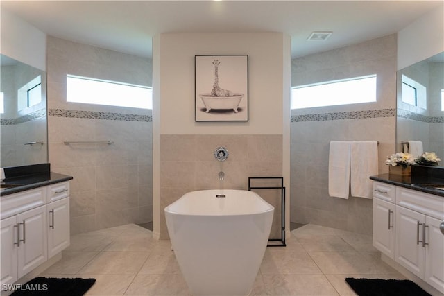 3318 SW 8th Pl, Cape Coral, FL 33914 - bathroom with tile walls, plenty of natural light, visible vents, and vanity