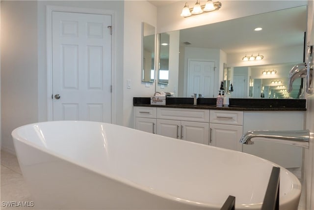 3318 SW 8th Pl, Cape Coral, FL 33914 - bathroom with tile patterned floors, vanity, and a freestanding tub