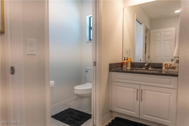 3318 SW 8th Pl, Cape Coral, FL 33914 - bathroom featuring toilet, baseboards, vanity, and tile patterned flooring