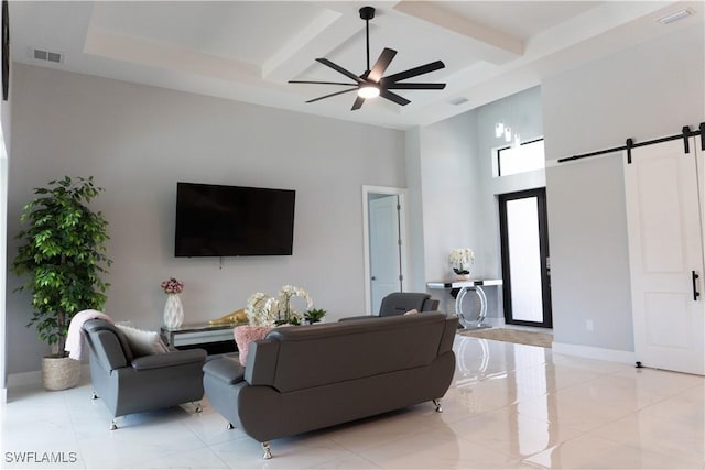 living area featuring visible vents, baseboards, a ceiling fan, a barn door, and coffered ceiling