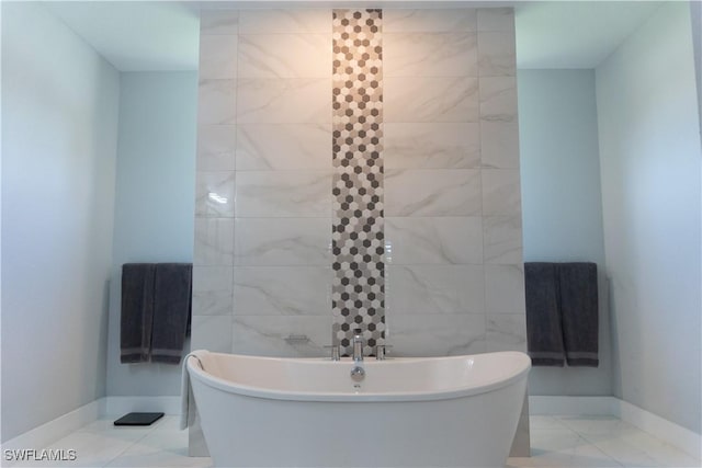 bathroom with a soaking tub and baseboards