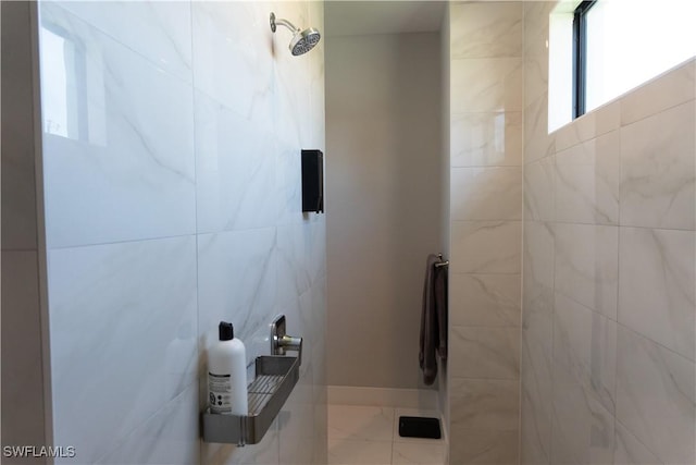 bathroom with tile walls and a tile shower