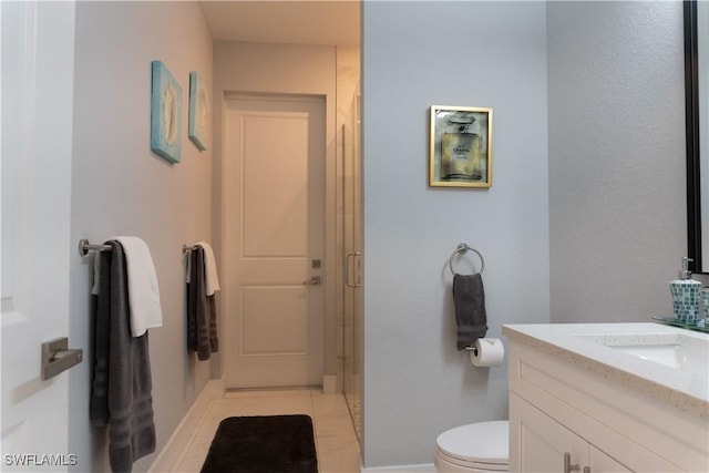 bathroom featuring vanity, toilet, baseboards, a shower stall, and tile patterned floors
